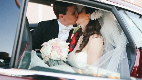 Bride and Groom kiss in Tesla