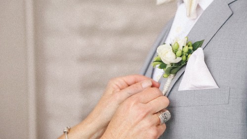 Bride pins on Groom's flower