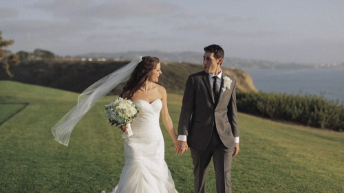 Bride and groom walking on golf course