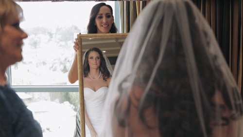 Bride checks makeup in mirror