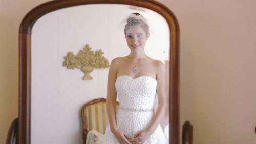 Bride looks in mirror at Calamigos