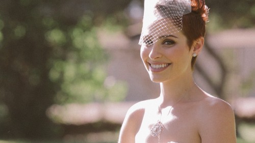 Bride in birdcage veil laughing