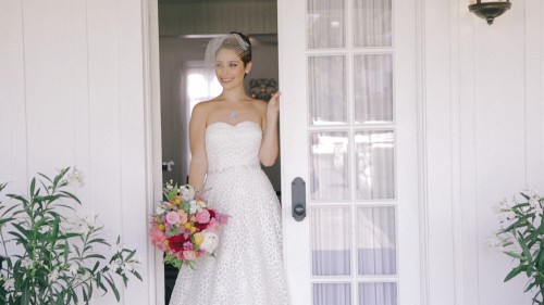 Bride with bouquet in doorway