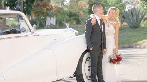 bride and groom with rolls royce