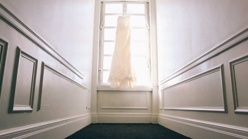 Wedding dress hanging in hallway