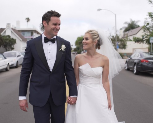 Bride and groom walk down street la jolla