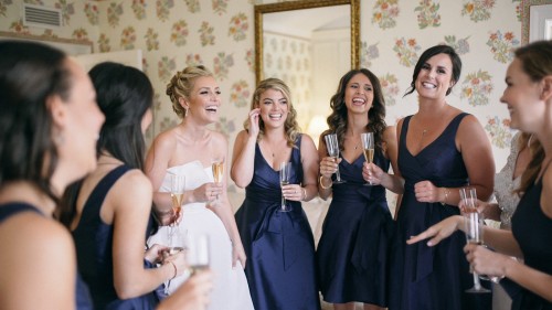 Bride and bridesmaids laughing toast Darlington house