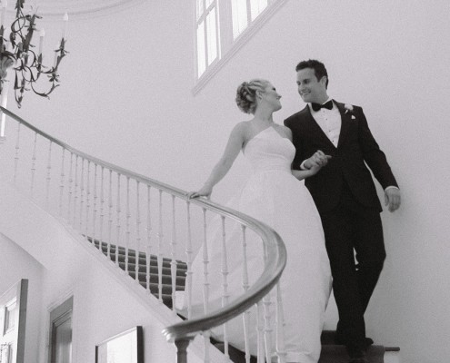 Bride and groom walking down stairs