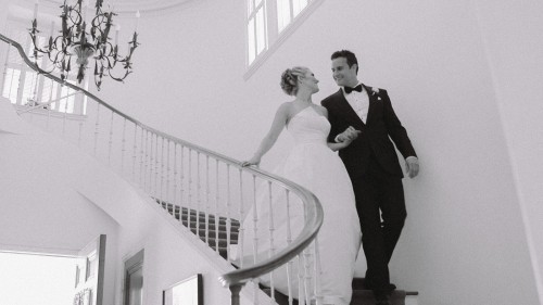 Bride and groom walking down stairs