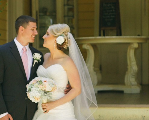Bride and groom in front of school house at Twin Oaks Garden Estate