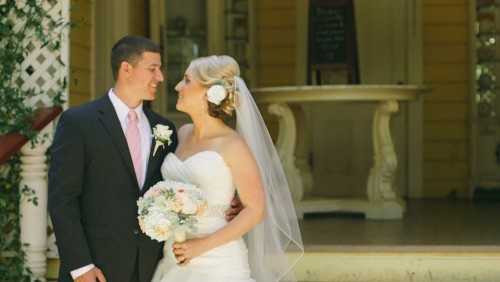 Bride and groom in front of school house at Twin Oaks Garden Estate