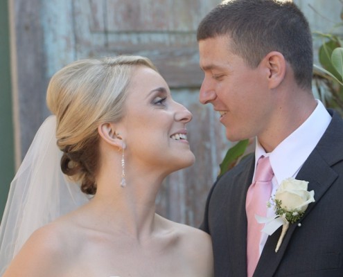 Bride and Groom in front of pretty background at Twin Oaks Garden Estate