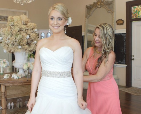 Bride putting on wedding dress San Diego Wedding Video at Twin Oaks Gardens and Estate