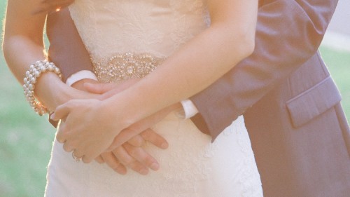 Bride and groom holding hands