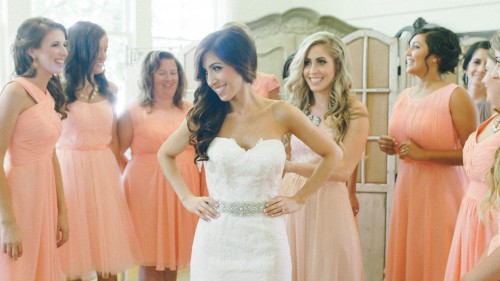 Bride putting on the dress