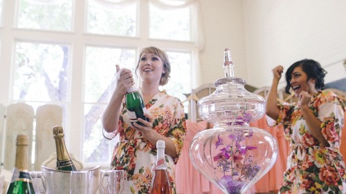  Bride's maid opening champagne