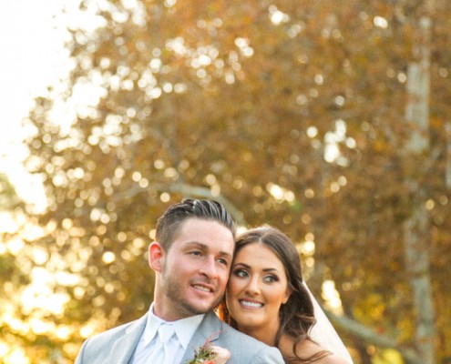 Bride and groom backlit at sunset at Lake Oak Meadows Wedding