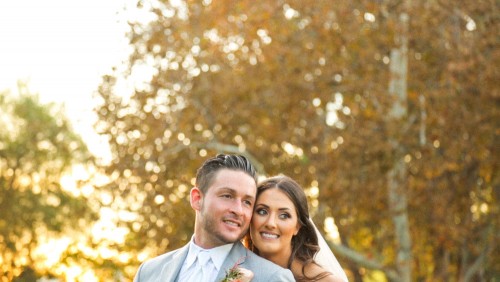 Bride and groom backlit at sunset at Lake Oak Meadows Wedding