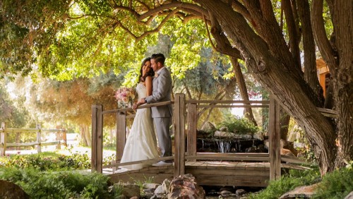 Bride and groom on bridge at Lake Oak Meadows in Temecula wedding video.