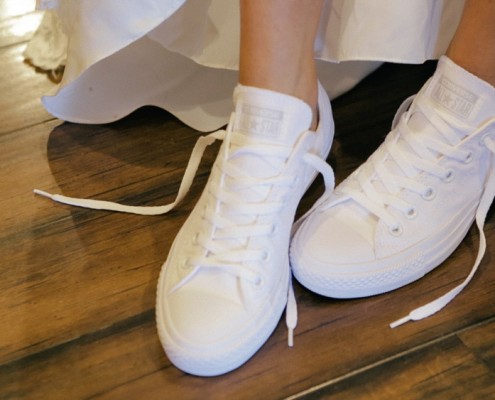 Bride wears cute tennis shoes at Lake Oak Meadows wedding venue in Temecula.