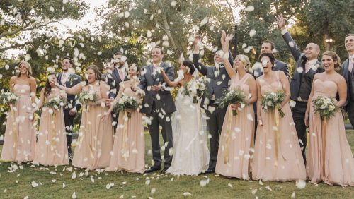 Bridal party throw flower petals at Mt Woodson Castle