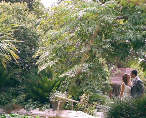 bride and groom by pond at San Diego Botanical Gardens