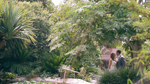 bride and groom by pond at San Diego Botanical Gardens