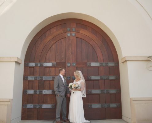 Bride and groom in front of Church