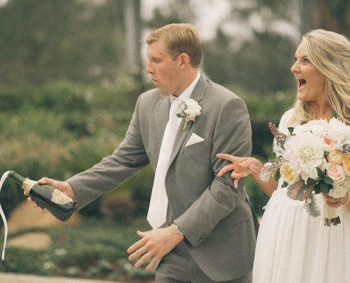 bride and groom crack champagne