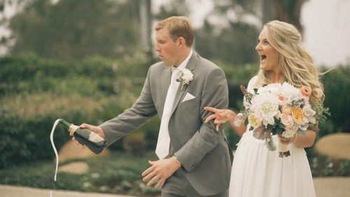 bride and groom crack champagne