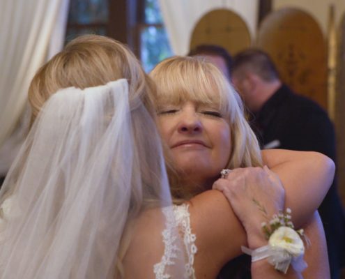 Mom and bride hug after wedding