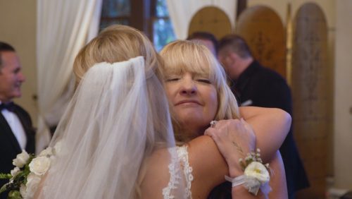 Mom and bride hug after wedding