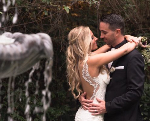 bride and groom by fountain