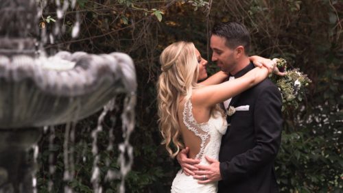 bride and groom by fountain 