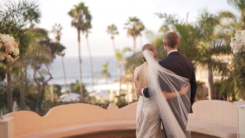 San Diego bride and groom gaze at the sea.