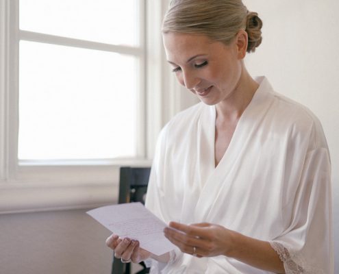 Bride Reading card before wedding