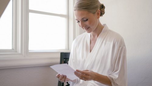 Bride Reading card before wedding