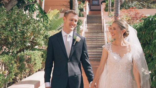 Bride and groom walk at La Valencia