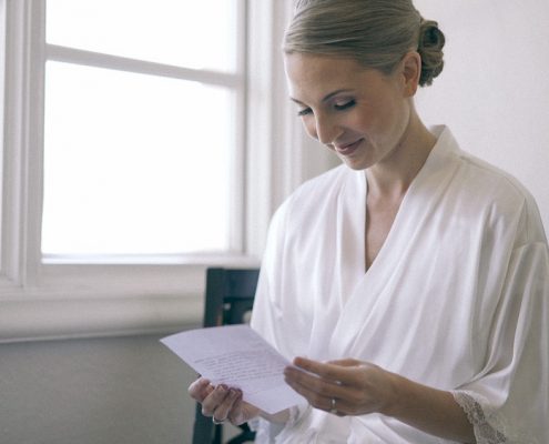 Bride reading card before ceremony