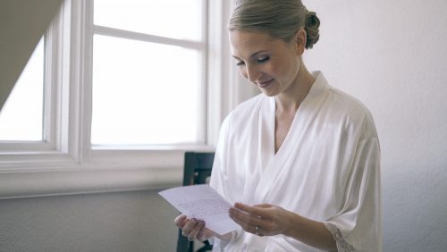 Bride reading card before ceremony