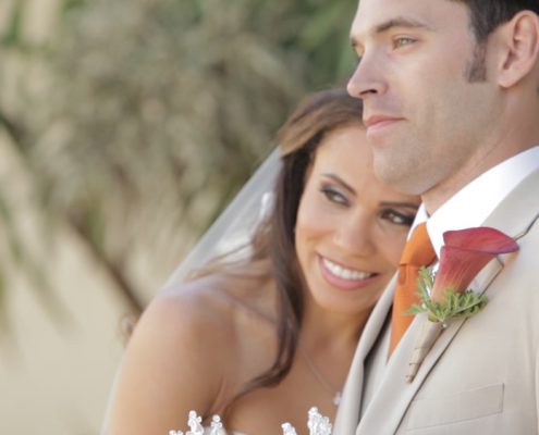 Scripps Seaside Forum bride and groom walk on beach