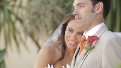 Scripps Seaside Forum bride and groom walk on beach