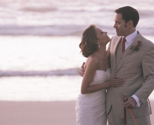 Scripps Seaside Forum bride and groom walk on beach