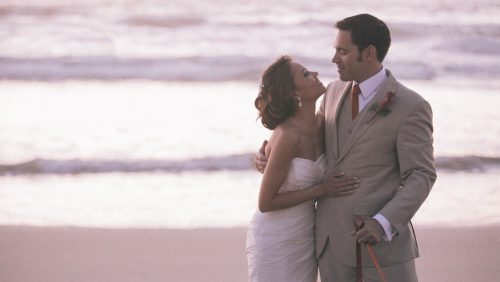 Scripps Seaside Forum bride and groom walk on beach