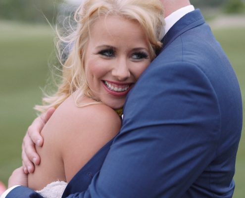 Crossings at Carlsbad wedding Groom holds bride on golf course