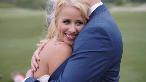 Crossings at Carlsbad wedding Groom holds bride on golf course