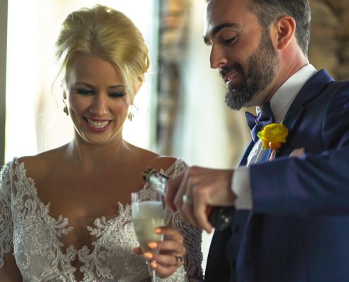 Groom pours champagne for bride