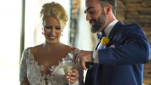 Groom pours champagne for bride