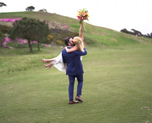 Crossings at Carlsbad wedding video bride holds bouquet in the air