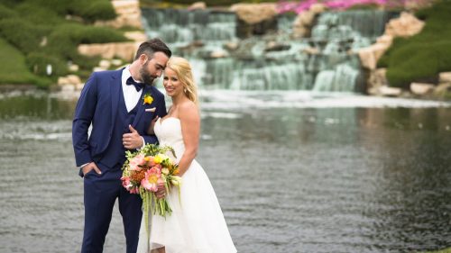 Bride and groom by waterfall